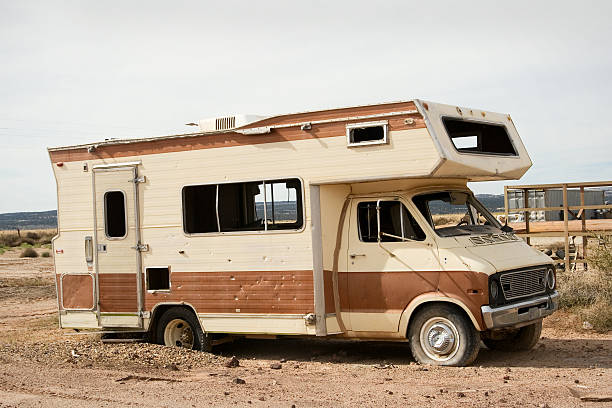 An old abandoned RV sitting near a junkyard. Taken in October 2010.